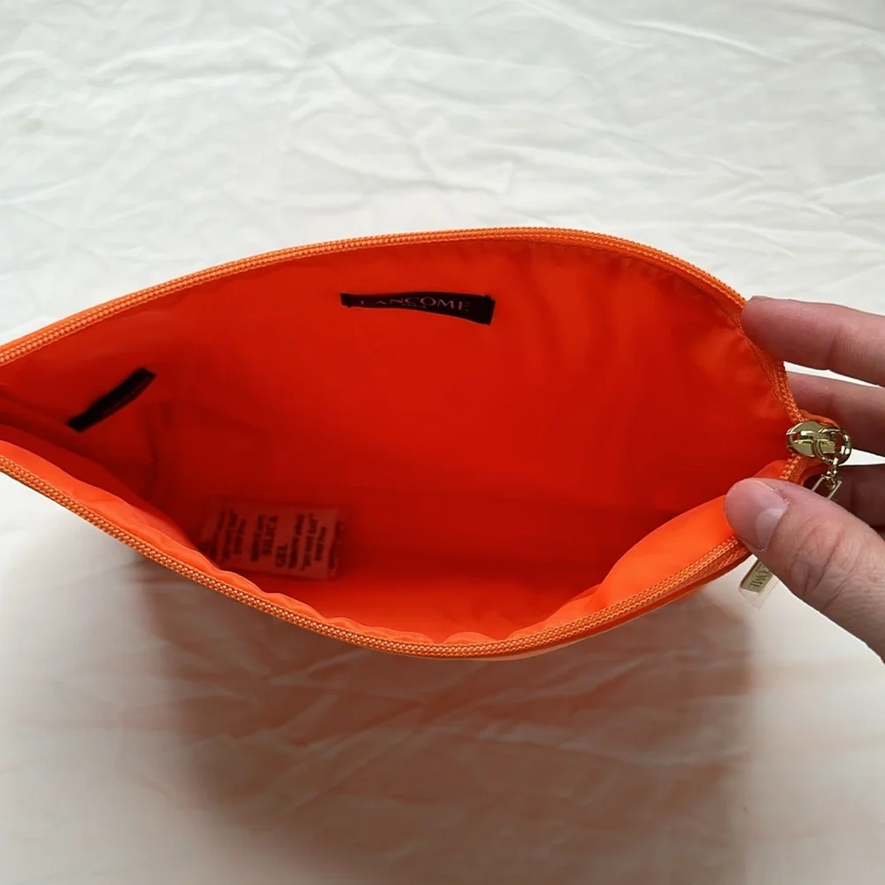 BEAND NEW! Vibrant Orange Cosmetic Bag with Glossy Finish and Zipper Closure.